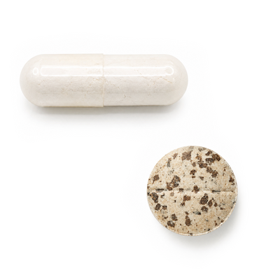 Two pills, one white and one speckled, on a white background