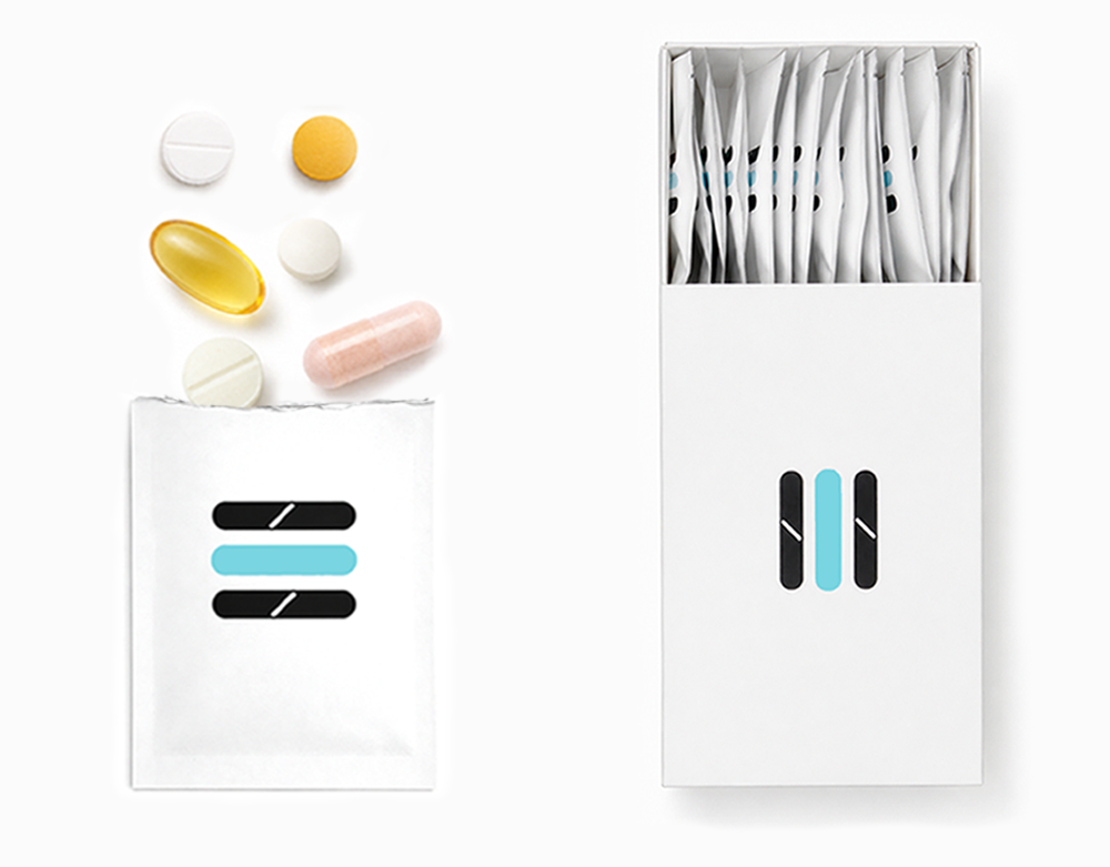 A clean studio shot of a white blister pack containing multiple individual white sachets, alongside several loose capsules and tablets in white, yellow, and pink. The packaging features a minimalist black and light blue stripe logo.