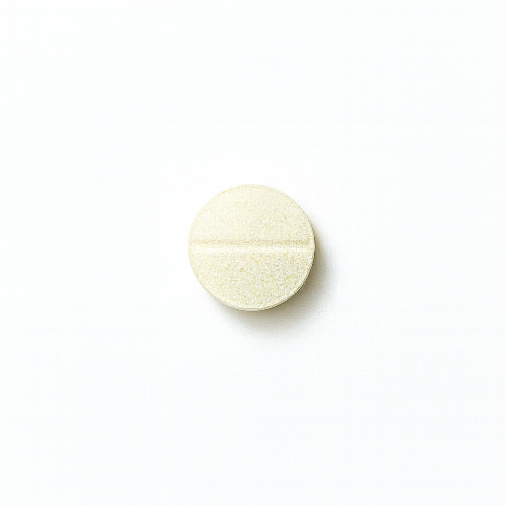 Yellow selenium pill on a white background
